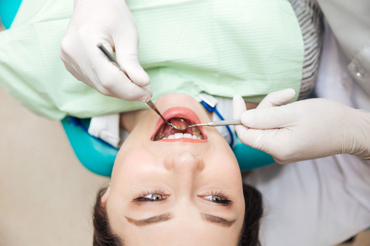 male patient undergoing scaling and polishing treatment at NoFrills Dental