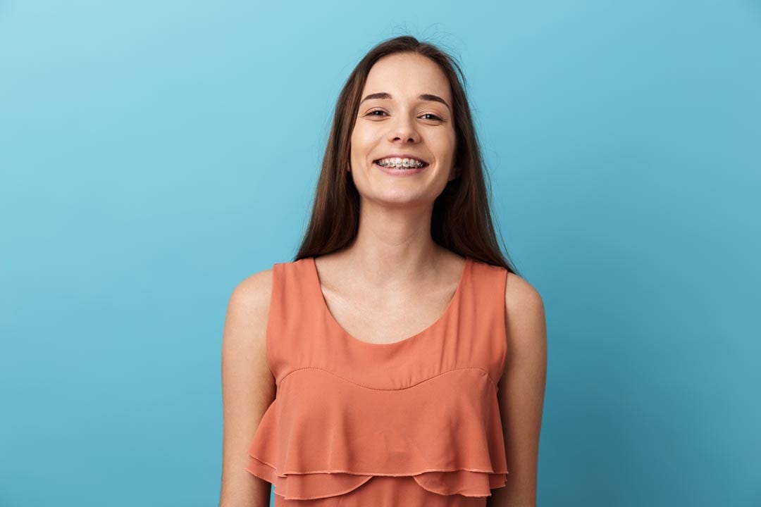 Braces-girl-standing lady smiling with her braces on