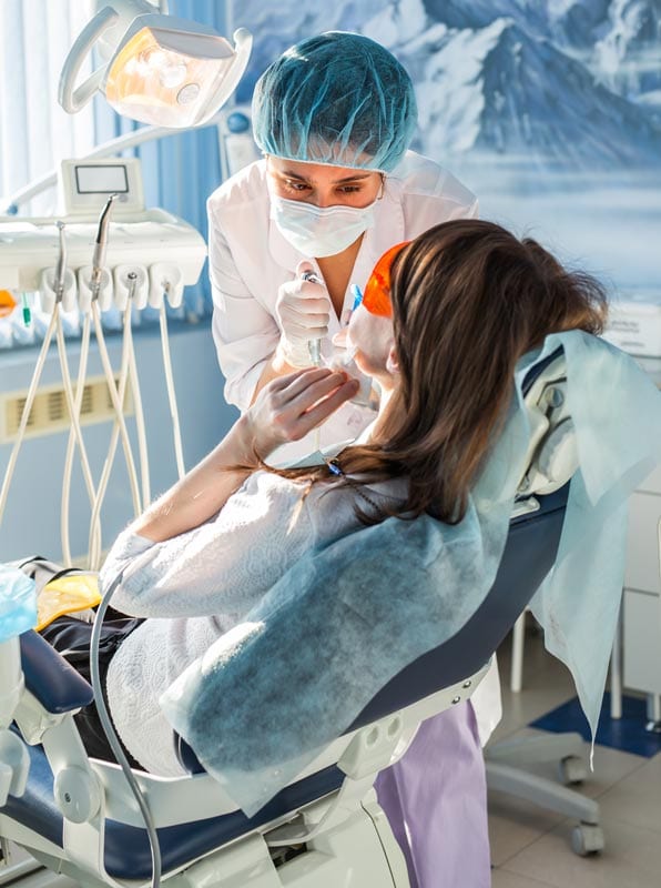 happy dental patient undergoing Invisalign aligner fitting