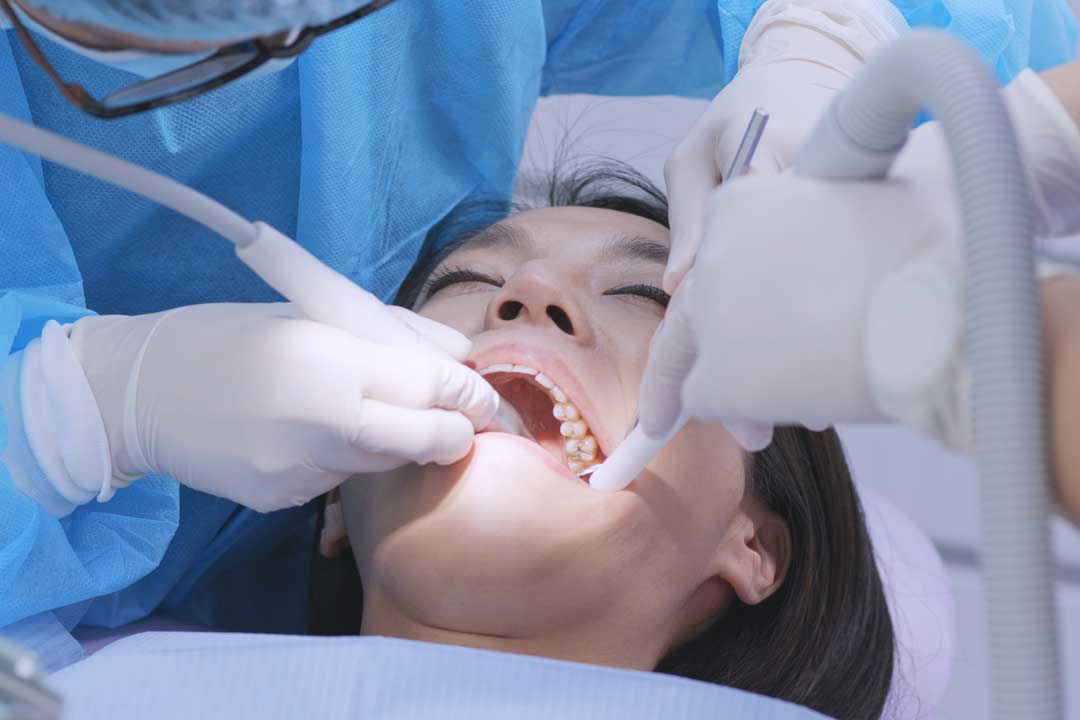 Asian lady undergoing Wisdom tooth surgery in Singapore