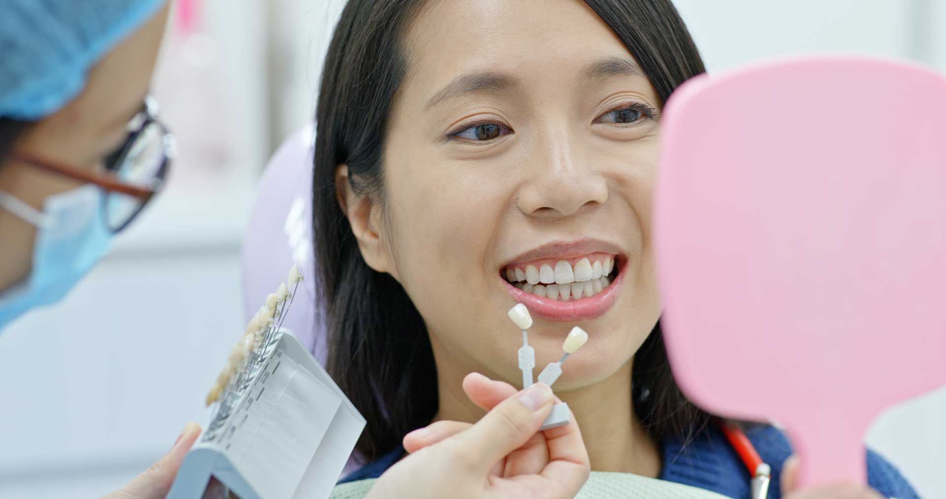 asian woman getting her teeth professionally whitened at a dental clinic in Singapore