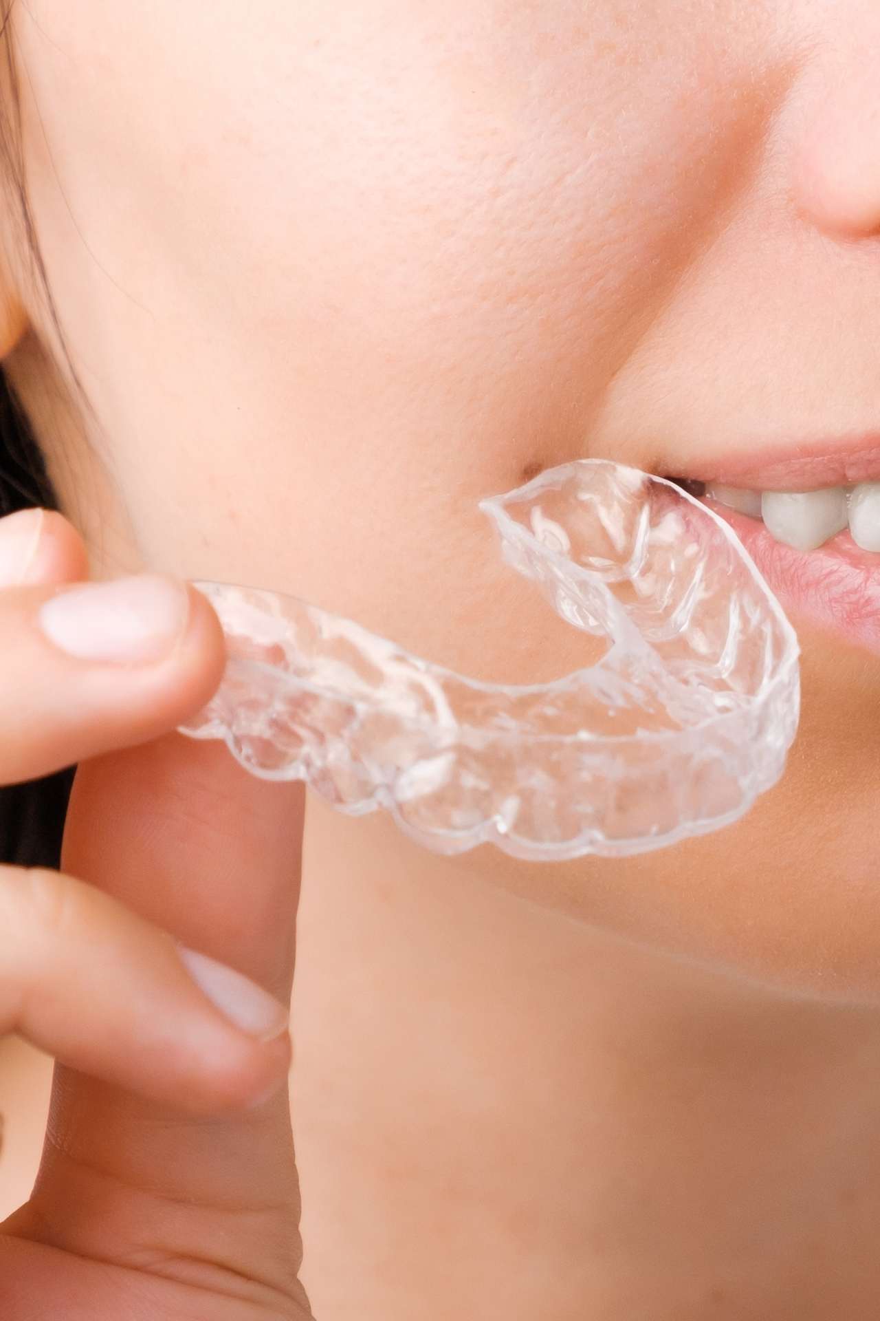 close up of woman holding invisalign