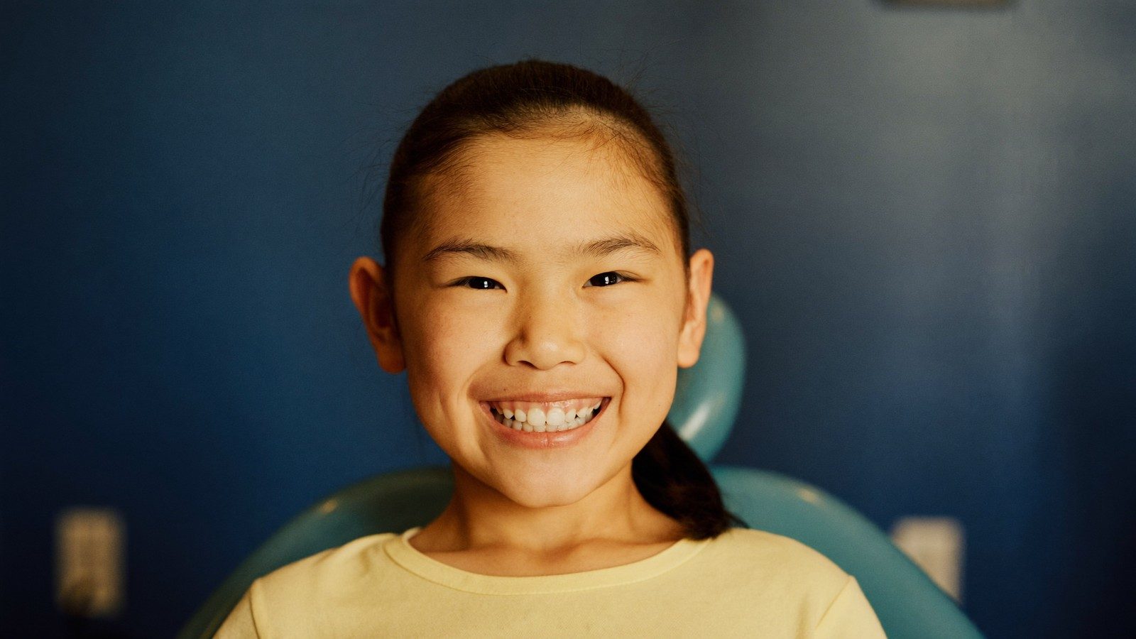 Young patient smiling at a Baby Bonus approved NoFrills Dental clinic