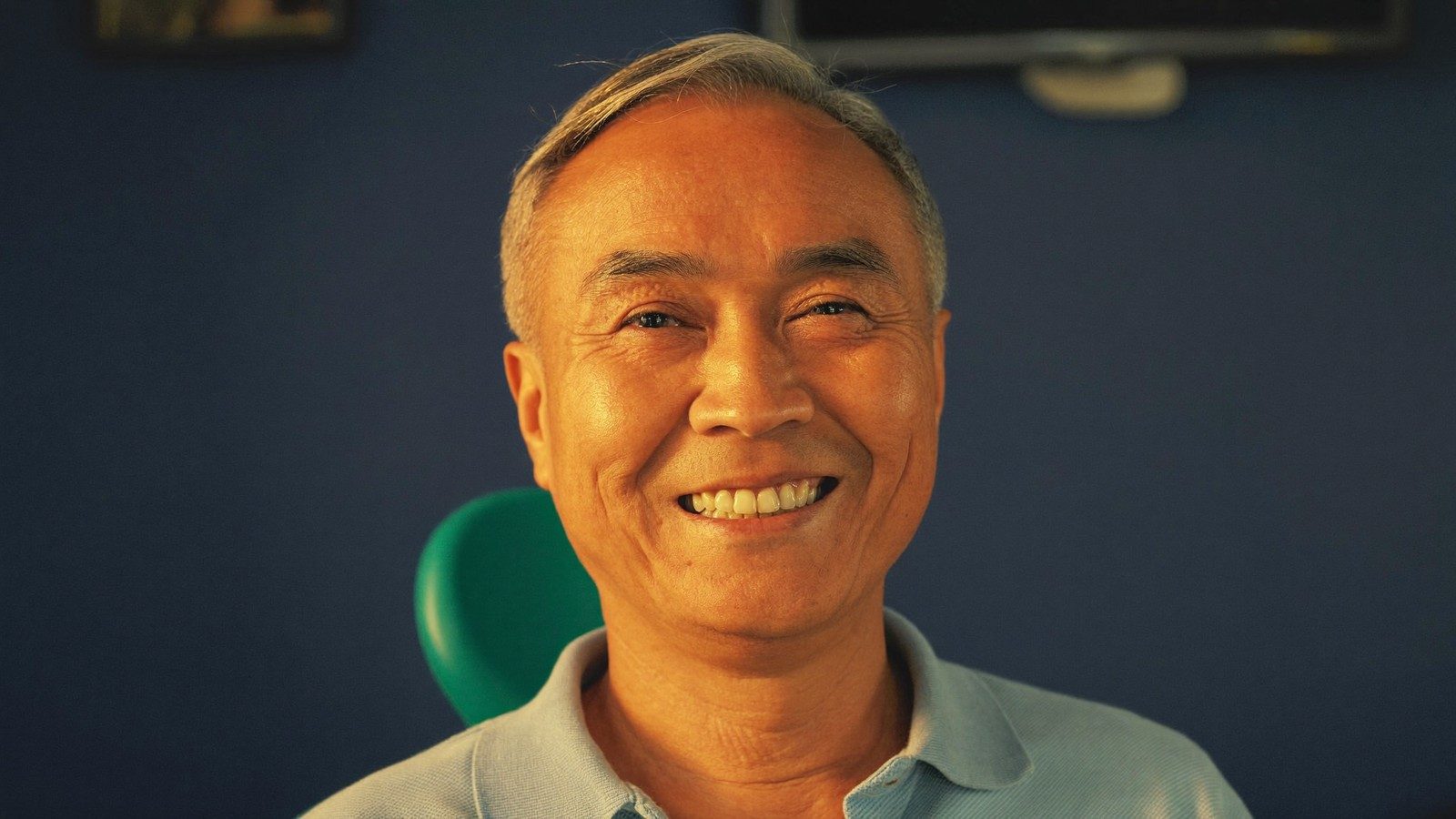 Smiling senior Singaporean man after subsidised dental treatment at a CHAS clinic