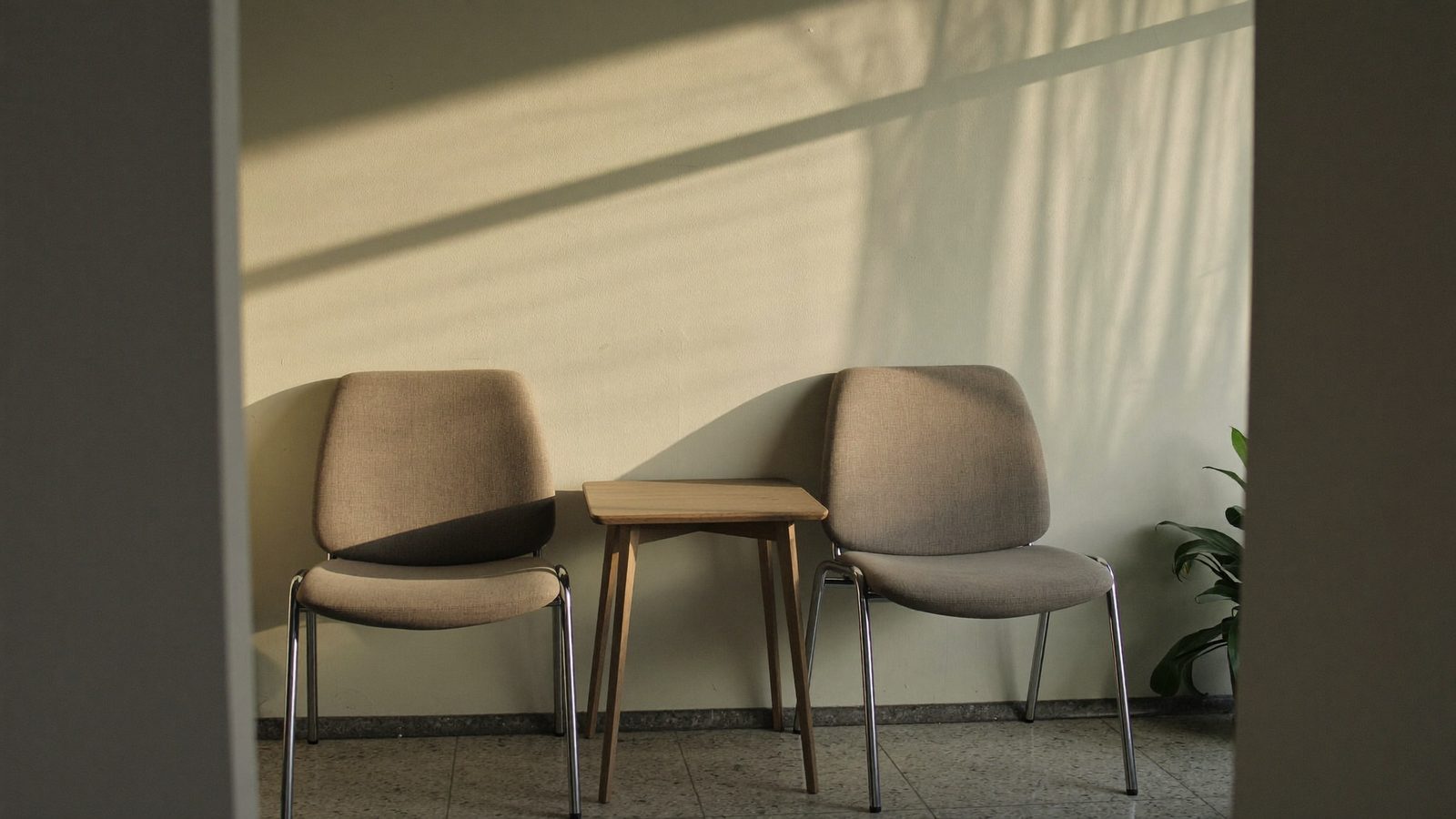 Sunlit empty corner of the waiting area at a NoFrills Dental clinic in Singapore