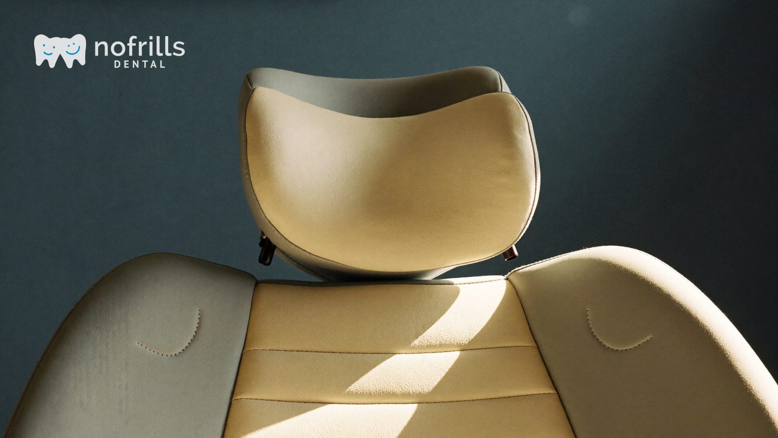 A dental chair headrest raised into a semi upright position in a NoFrills Dental treatment room in Singapore.